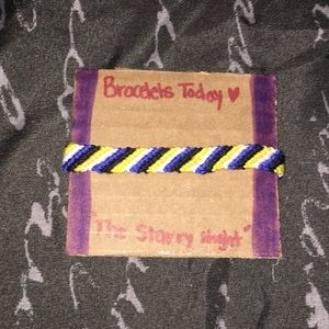 A striped styled bracelet made of cotton string.